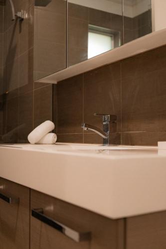 a bathroom with a sink and a mirror at Apartment on James in Bicheno