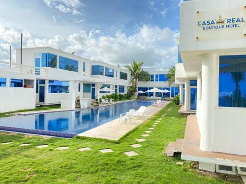 an exterior view of a villa with a swimming pool at Hotel Casa Real Boutique Monterrico in La Candelaria