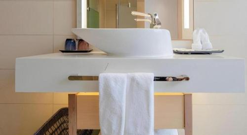 a bathroom with a sink and a towel on a counter at Lavande Hotel Changsha South High-speed Railway Station Xiyingmen in Changsha