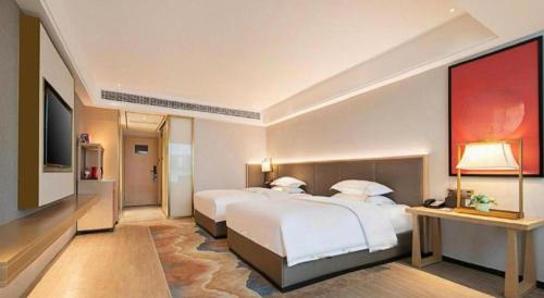 Ένα ή περισσότερα κρεβάτια σε δωμάτιο στο Echeng Hotel Enshi Minzu Road