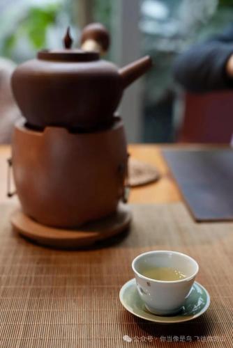 a teapot and a cup of tea on a table at Wuyu Sky Garden Hotel Chongqing Zoo & Yangjiaping The Mixc Light rail in Chongqing