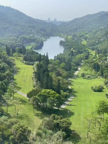 an aerial view of a golf course with a lake at 南屿轻奢影院酒店厦门高崎国际机场店 in Xiamen