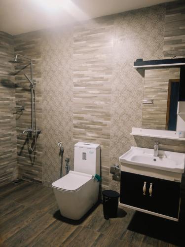 a bathroom with a toilet and a sink at Sunset Mirage Villa in Unawatuna