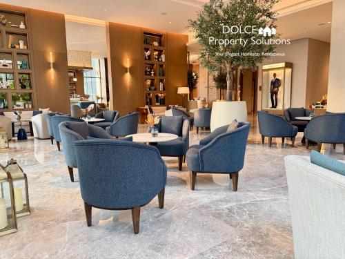 a lobby with chairs and tables in a store at Address Beach Resort Residences Bahrain in Manama