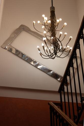 a chandelier hanging from a stairway in a house at CityHotel Cristina Vicenza in Vicenza
