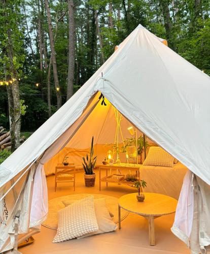 a white tent with a table in front of it at FujiSaunaVillage グランピングテント in Fujikawaguchiko