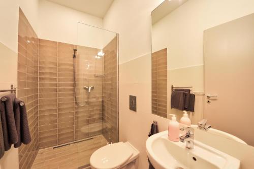 a bathroom with a shower and a sink and a toilet at Villa Oliver 2 Siófok in Siófok