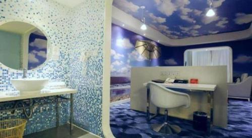 a bathroom with a sink and a mirror at Grand Nest Hotel (Tang Jia Wan Beach) in Zhuhai