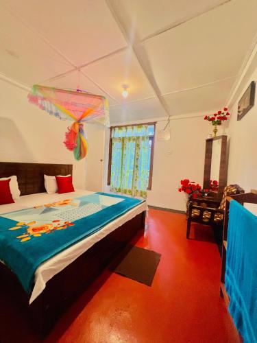 a bedroom with a large bed in a room at Dilani Adamspeak RiverStay in Adams Peak