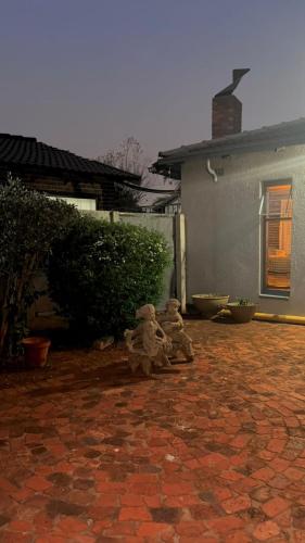 two teddy bears sitting on a brick patio at Heather Guest House in Alberton