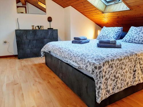 a bedroom with a bed with blue pillows on it at Holiday Home IL VULCANO in Quartino
