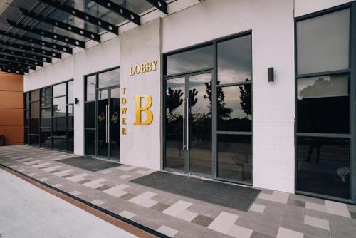 a large building with a sign on the side of it at Family Friendly Unit in K Avenue in Donggongon