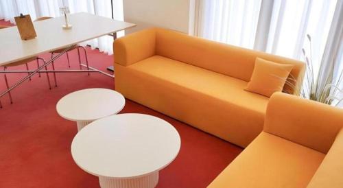 a living room with a yellow couch and a table at CS Premier Hotel in Seoul