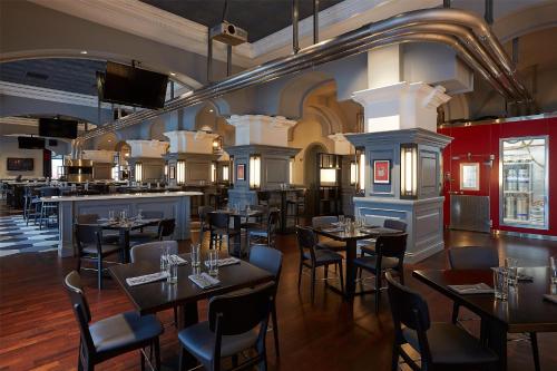 a restaurant with tables and chairs and a bar at Manchester Grand Hyatt San Diego in San Diego