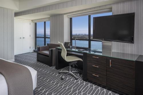 a hotel room with a desk with a tv at Manchester Grand Hyatt San Diego in San Diego