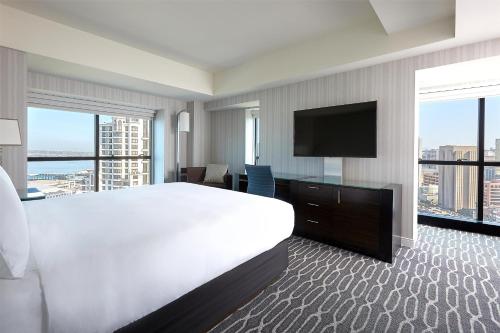 a hotel room with a large bed and a flat screen tv at Manchester Grand Hyatt San Diego in San Diego