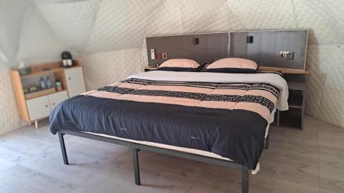 a bedroom with a large bed with pink pillows at Dream Estate Resort in Senggigi 