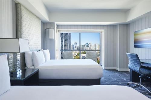 a hotel room with two beds and a balcony at Manchester Grand Hyatt San Diego in San Diego