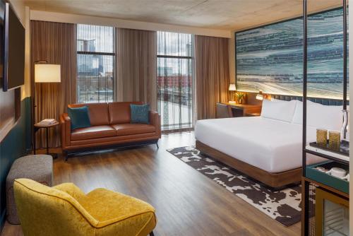 a hotel room with a bed and a chair at Caption By Hyatt Downtown Nashville - The Gulch in Nashville