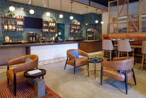 a bar with chairs and tables in a restaurant at Caption By Hyatt Downtown Nashville - The Gulch in Nashville