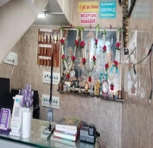a store with flowers on the wall of a room at Temple View Residency in Tirukkadaiyūr