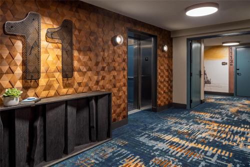 a lobby of a hotel with a tile wall at Caption By Hyatt Downtown Nashville - The Gulch in Nashville