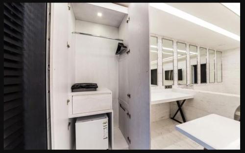 a bathroom with a sink and a vanity with mirrors at Hotel Forestar in Seoul