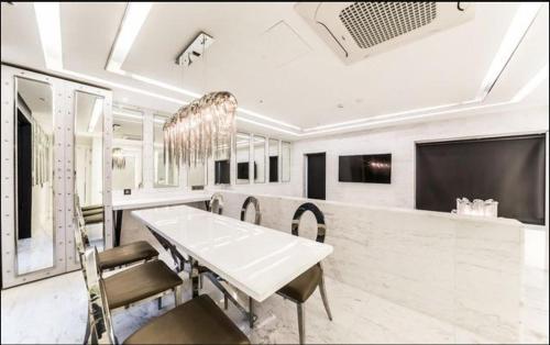 a dining room with a white table and chairs at Hotel Forestar in Seoul