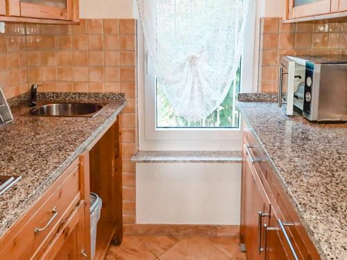 a kitchen with a sink and a window at Bungalow 1 in Quetzin