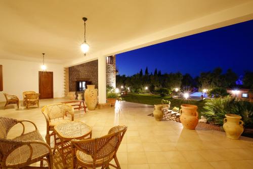 a patio with chairs and tables at night at Agriturismo Posta Pastorella in Vieste