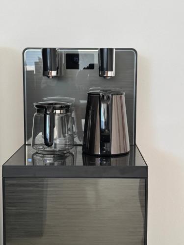 a counter with two coffee makers on top of it at The Seminyak Suites Private Villas in Seminyak
