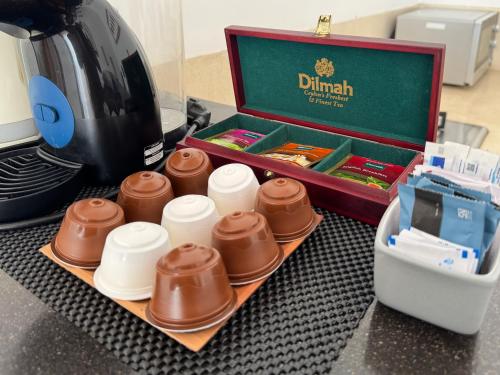 a box of chocolates on a tray next to a coffee maker at The Seminyak Suites Private Villas in Seminyak