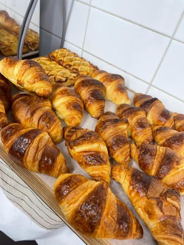 a tray of croissants and other pastries in a bakery at JB Plus Hotel in Busan