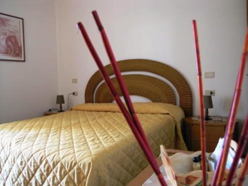 a bedroom with a bed with four sticks at Agriturismo Podere San Michele in San Vincenzo