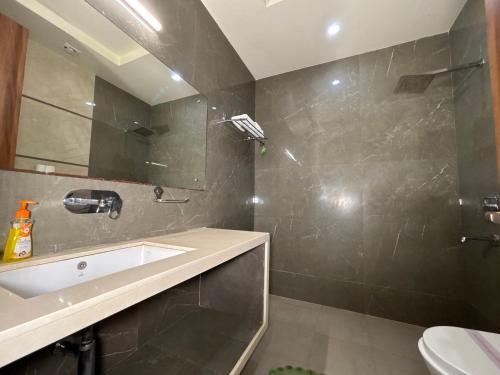 a bathroom with a sink and a mirror at The Taj Vista Agra -walking distance to Taj Mahal in Agra