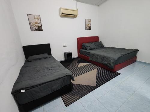 Ένα ή περισσότερα κρεβάτια σε δωμάτιο στο Rahmah Homestay Temerloh