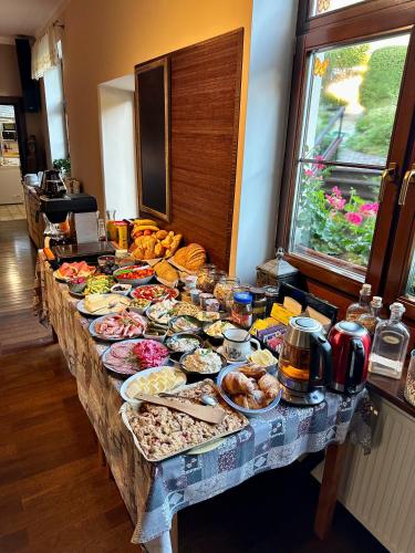 a long table with many plates of food on it at Reitmayer in Smokovce