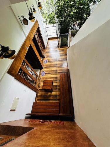 a staircase in a house with wooden floors at Deep Rich Farm villa Munnar in Anachal