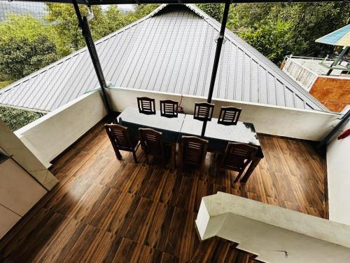 an overhead view of a table and chairs on a roof at Deep Rich Farm villa Munnar in Anachal