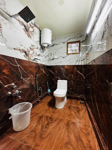 a bathroom with a toilet in a room at Deep Rich Farm villa Munnar in Anachal