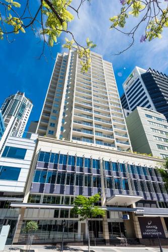 a tall building with tall buildings in the background at Oaks Brisbane Lexicon Suites in Brisbane