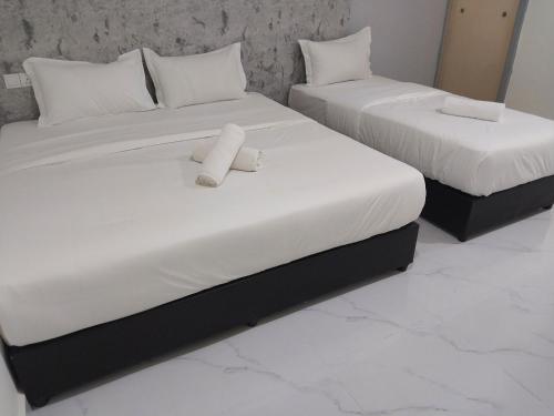 Postel nebo postele na pokoji v ubytování Paradise Resort Pantai Cenang