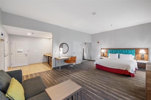 a hotel room with a bed and a desk at Hampton Inn & Suites Madera in Madera