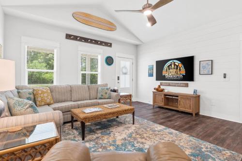 a living room with a couch and a tv at Reminiscing in Eastpoint