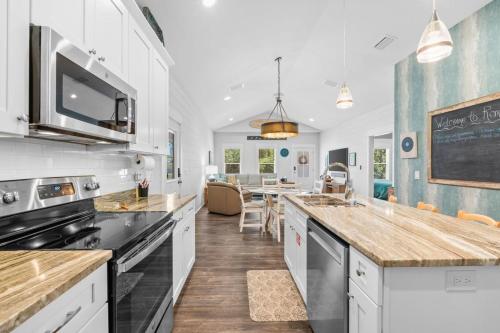 a kitchen with white cabinets and a counter top at Reminiscing in Eastpoint