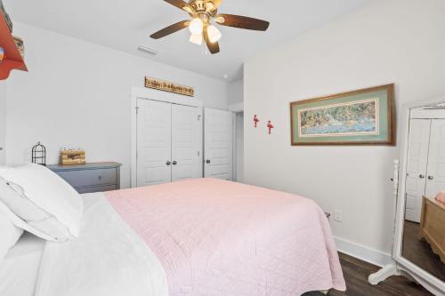 a bedroom with a bed and a ceiling fan at Reminiscing in Eastpoint