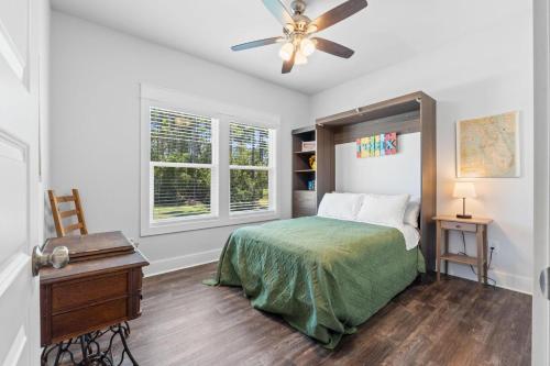 a bedroom with a bed and a ceiling fan at Reminiscing in Eastpoint
