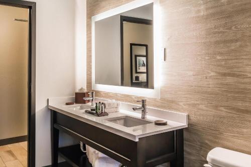 a bathroom with a sink and a mirror at Marina Bay Hotel & Suites, an Ascend Collection Hotel in Chincoteague