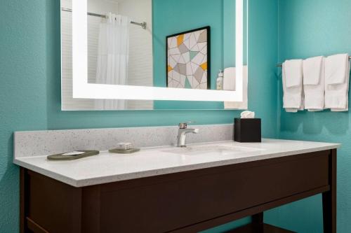 a bathroom with a sink and a mirror at La Quinta by Wyndham Montgomery in Montgomery