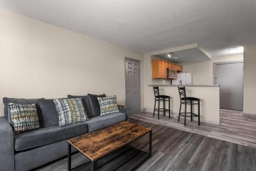 a living room with a couch and a table at Days Inn and Suites by Wyndham Hammond, IN in Hammond